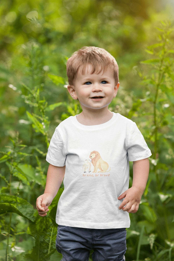 Toddler smiling wearing the Be Kind Be Brave Tee in soft cotton.